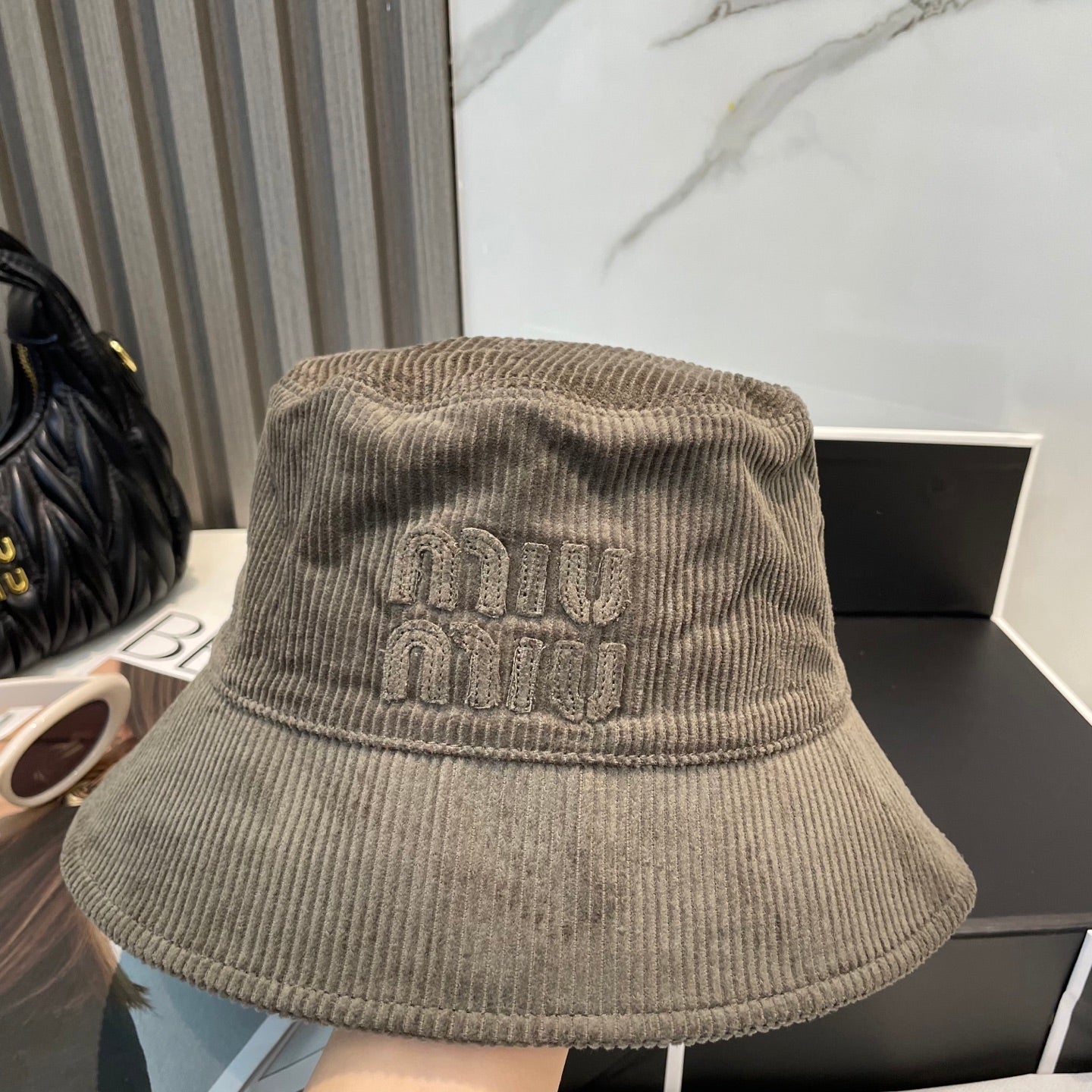 MM BUCKET IN MUTED BROWN VELVET WITH LOGO